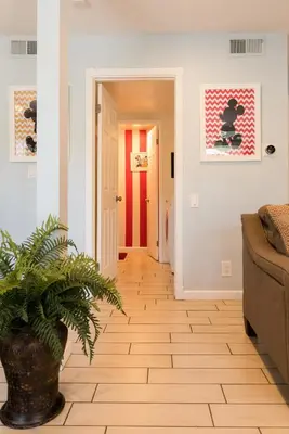 a hallway with a potted plant and a red door at Magicwayvillas Micky's Playground Pool & Spa - Walking TO Disney in Anaheim
