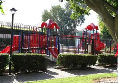 a playground with a slide in a park at MagicwayVillas Mick's ClockHouse Pool & Spa - Walk to Disneyland in Anaheim
