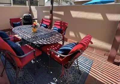 a table and chairs sitting on a balcony with a table and chairs at MagicwayVillas Mick's ClockHouse Pool & Spa - Walk to Disneyland in Anaheim