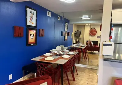 a dining room with blue walls and tables and chairs at MagicwayVillas Mick's ClockHouse Pool & Spa - Walk to Disneyland in Anaheim