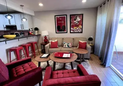 a living room with a couch and tables and a kitchen at MagicwayVillas Mick's ClockHouse Pool & Spa - Walk to Disneyland in Anaheim