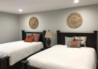 two beds sitting next to each other in a bedroom at Magicwayvillas Micky's HideAway in Fullerton