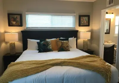 a bedroom with a large bed with two lamps at Magicwayvillas Micky's HideAway in Fullerton