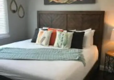 a bed with many pillows on it in a bedroom at Magicwayvillas Micky's HideAway in Fullerton