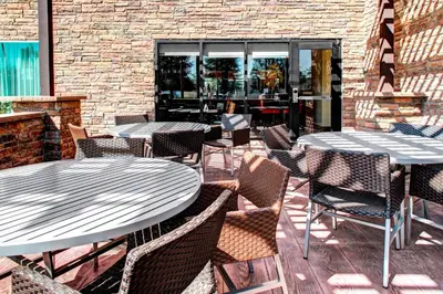 two tables and chairs sitting on a patio at TownePlace Suites by Marriott Bakersfield West in Bakersfield