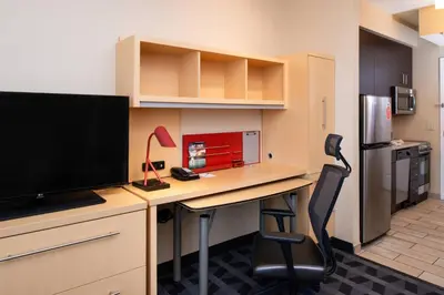 an office with a desk with a television and a chair at TownePlace Suites by Marriott Bakersfield West in Bakersfield