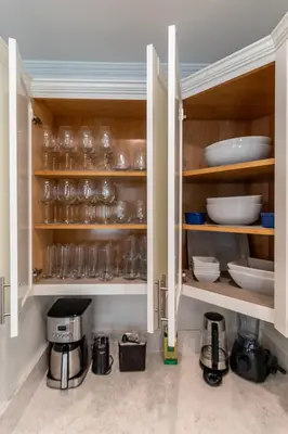 a kitchen filled with glasses and dishes on shelves at Family Beach House, 400ft to Beach, Parking, BBQ in Long Beach