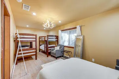 a bedroom with a bed and two bunk beds at Wraparound Deck and Grill Wrightwood Cabin Near PCT in Wrightwood