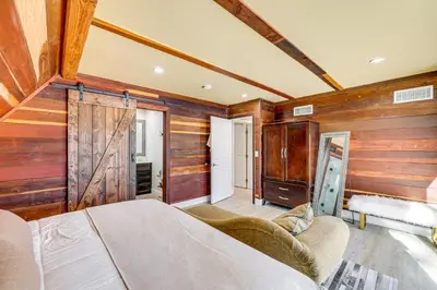 a bedroom with wooden walls and a bed in a room at Wraparound Deck and Grill Wrightwood Cabin Near PCT in Wrightwood