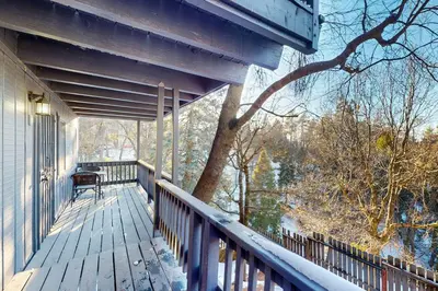 a porch of a house with a tree on it at Arosa Pines in Crestline