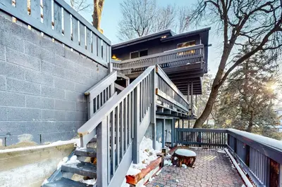 a building with stairs and a table on a patio at Arosa Pines in Crestline