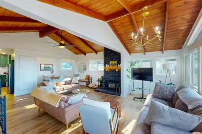 a living room with couches and a fireplace at Arosa Pines in Crestline