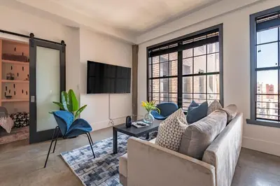 a living room with a couch and a tv at Urban Luxe LOFT in Los Angeles