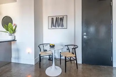 a table and chairs in a room with a black door at Urban Luxe LOFT in Los Angeles