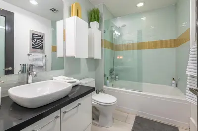 a bathroom with a sink and a toilet and a tub at Urban Luxe LOFT in Los Angeles