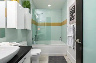 a bathroom with a tub and a toilet and a sink at Urban Luxe LOFT in Los Angeles