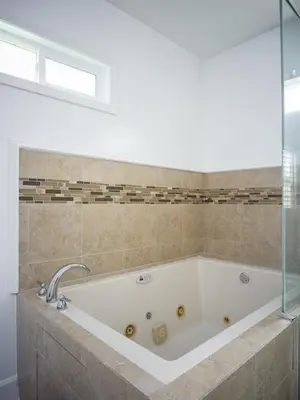 a white bath tub in a bathroom with a window at Fire Pit & Game Room 4 Beds Near Beach, LAX & SoFi in Lawndale