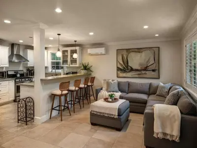 a living room with a couch and a kitchen at Fire Pit & Game Room 4 Beds Near Beach, LAX & SoFi in Lawndale