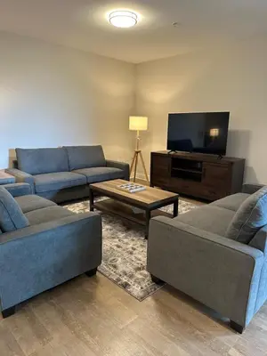 a living room with two couches and a tv at Avalon Wilshire in Los Angeles