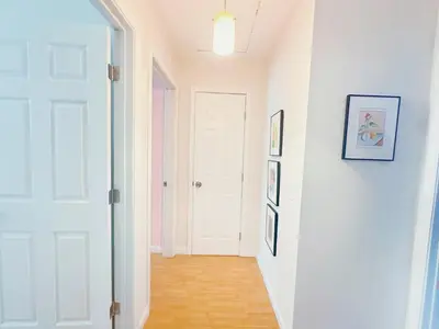 a hallway with white walls and a white door at Brea Mall romantic two-bedroom house in Fullerton