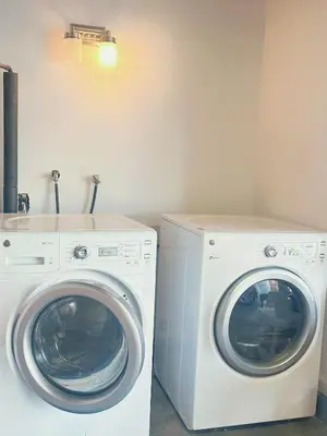 a washing machine and a dryer in a room at Brea Mall romantic two-bedroom house in Fullerton