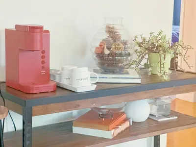 a table with a coffee maker and books on it at Brea Mall romantic two-bedroom house in Fullerton