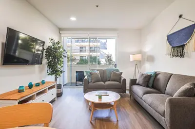 a living room with a couch and a table at Spacious 2BDR in SM - 5 minutes walk to the beach! in Los Angeles