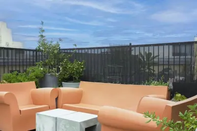 a patio with orange furniture and a white table at City Lights Loft Downtown LA Month Plus in Los Angeles