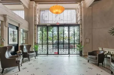a lobby with chairs and a large glass door at City Lights Loft Downtown LA Month Plus in Los Angeles