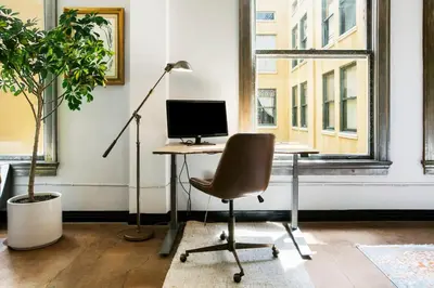 an office with a desk with a computer and a chair at City Lights Loft Downtown LA Month Plus in Los Angeles