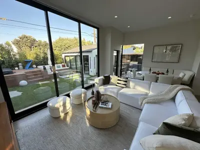 a living room with white furniture and a large window at Zenice Beach Luxury Home - Sauna, Cold Plunge, Spa in Los Angeles