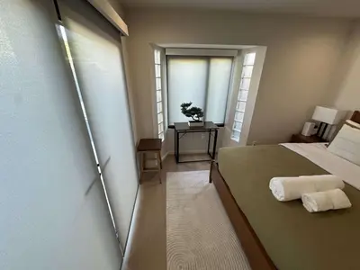 a small room with a bed and a window at Zenice Beach Luxury Home - Sauna, Cold Plunge, Spa in Los Angeles