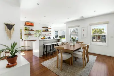 a kitchen and dining room with a table and chairs at Sun-Drenched Spanish Manor Home in Mar Vista in Los Angeles