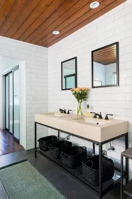 a bathroom with a counter with two sinks and two mirrors at Sun-Drenched Spanish Manor Home in Mar Vista in Los Angeles