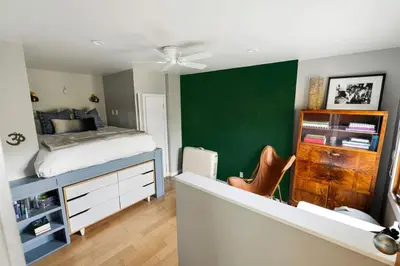 a bedroom with a bed and a green wall at Hillside Hideaway with Deck And Spa in Topanga Canyon in Topanga