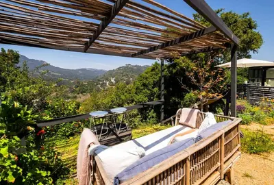 a porch with a wooden pergola and a bench at Canyon Crest Cottage and Garden in Topanga Canyon in Topanga