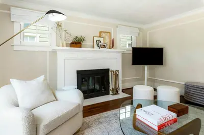 a living room with a white couch and a fireplace at Charming Walk Street Home - A Venice Beach Hideaway in Los Angeles