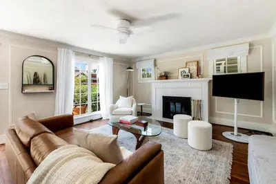 a living room with a couch and a tv at Charming Walk Street Home - A Venice Beach Hideaway in Los Angeles