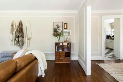 a living room with a brown couch in a room at Charming Walk Street Home - A Venice Beach Hideaway in Los Angeles