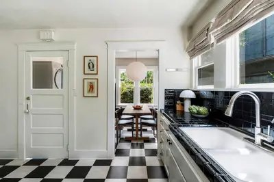 a kitchen with a black and white checkered floor at Charming Walk Street Home - A Venice Beach Hideaway in Los Angeles