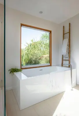 a white bathroom with a window and a white tub at San Juan Featured in Architectural Digest Plus Sauna in Los Angeles