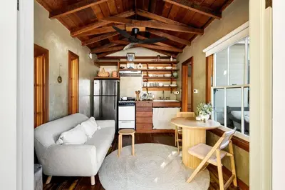 a living room with a couch and a kitchen at Hillside Hideaway Guest House in Topanga Canyon in Topanga