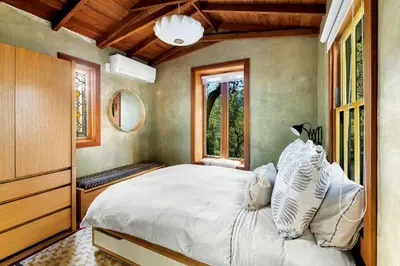 a bedroom with a large white bed and a window at Hillside Hideaway Guest House in Topanga Canyon in Topanga