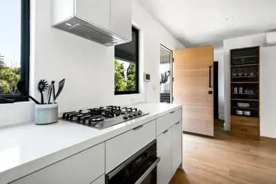 a kitchen with white counters and a stove top oven at Westminster Bungalow - Front House with Private Entrance in Los Angeles