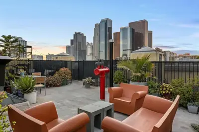 a patio with chairs and a fire hydrant and a city at Skyline View Loft w Kitchen DTLA Exclusively Month Plus in Los Angeles