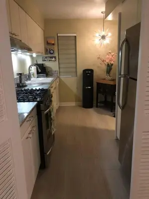 a kitchen with a stove and a refrigerator at Best Location West LA Spacious condo with hottub in Los Angeles