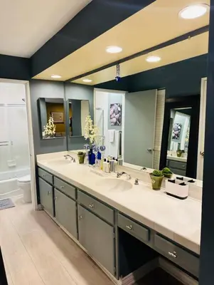 a bathroom with two sinks and a large mirror at Best Location West LA Spacious condo with hottub in Los Angeles