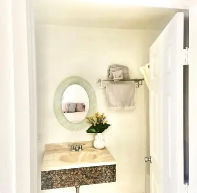 a bathroom with a sink and a mirror at Sunrise Inn in Inyokern