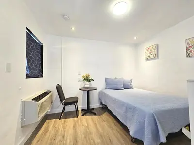 a bedroom with a bed and a table with a chair at Sunrise Inn in Inyokern