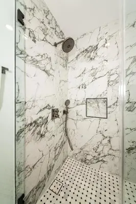 a bathroom with a shower with a black and white tiling at A Brand New Home In Los Angeles in Van Nuys County Court Heliport